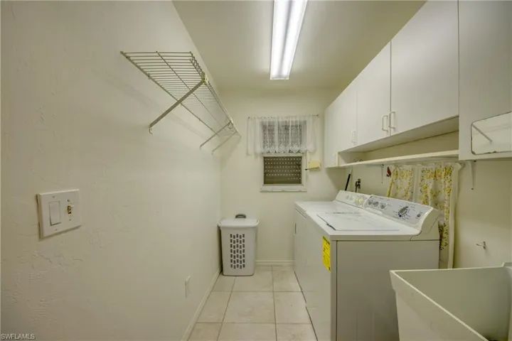 Large Laundry Room with tub and lots of cabinet space.