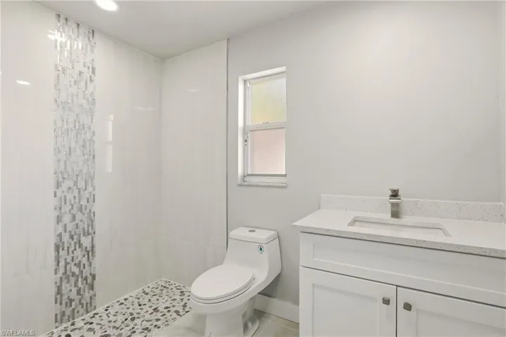 Full bathroom with vanity and a walk in shower