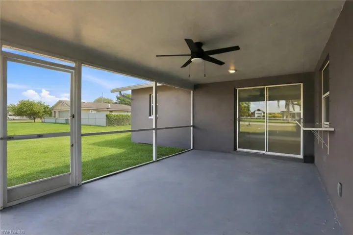 Unfurnished sunroom featuring a ceiling fan