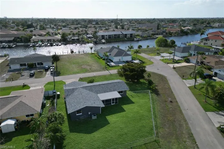 Aerial perspective of suburban area featuring a large body of water