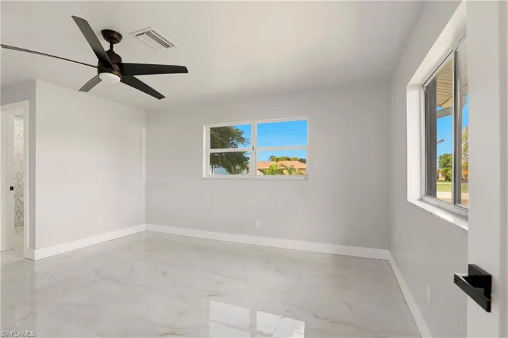 Spare room featuring baseboards and ceiling fan