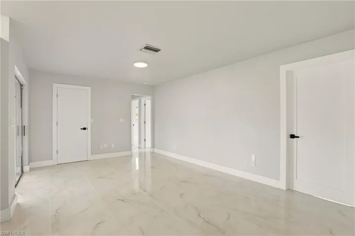 Empty room featuring baseboards and light marble finish flooring