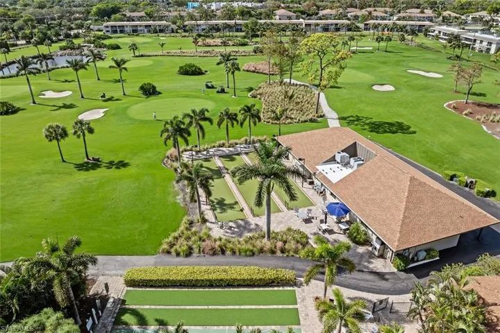 Expansive golf course setting featuring manicured greens and sand traps