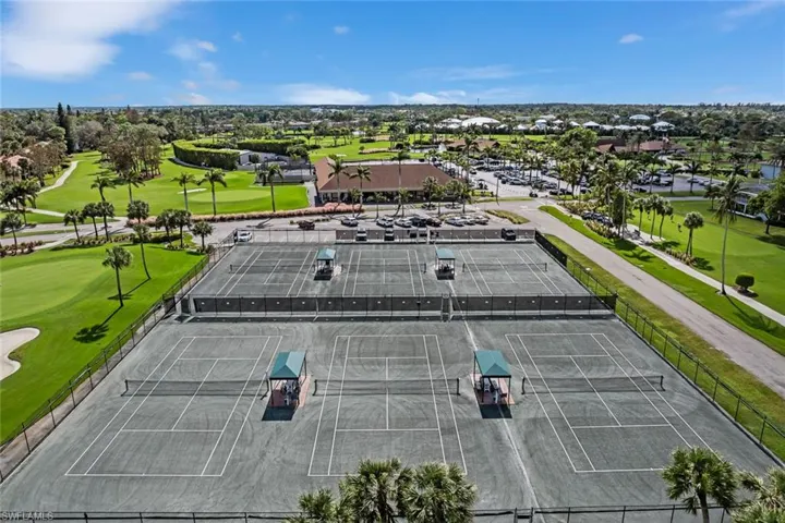 Four hard tennis courts with green surfacing and white line markings