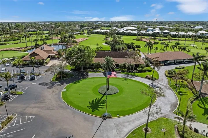 Aerial perspective showcasing a multi-building complex surrounded by a golf course