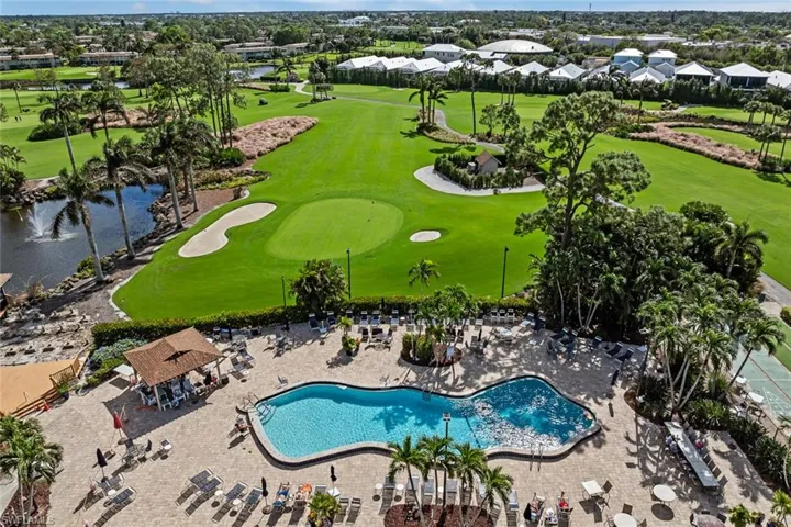 Resort-style pool area featuring a freeform pool, surrounding patio, and dedicated lounging spaces