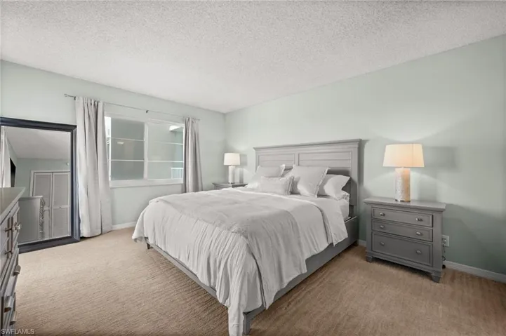 Bedroom featuring a textured ceiling and carpet floors