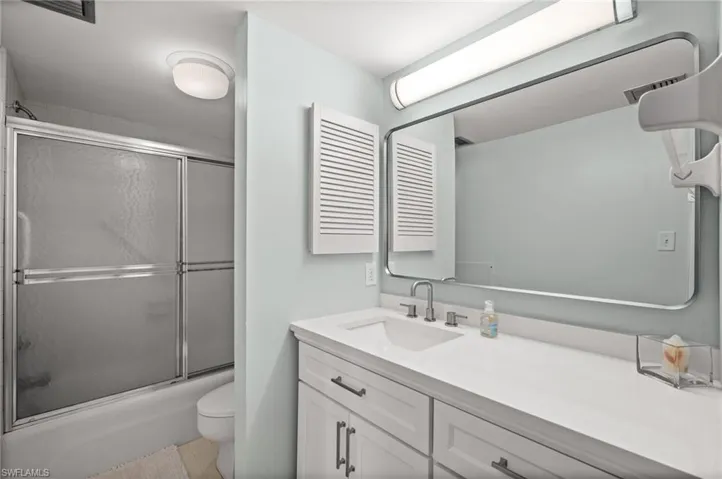 Full bathroom with vanity and shower / bath with glass door