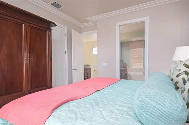 Master Bedroom with ornamental molding and ensuite bath