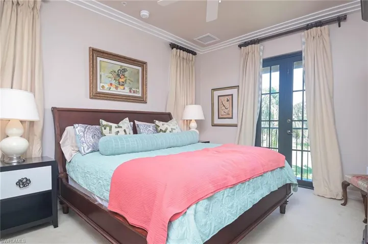 Master bedroom with ceiling fan, french doors, and access to exterior