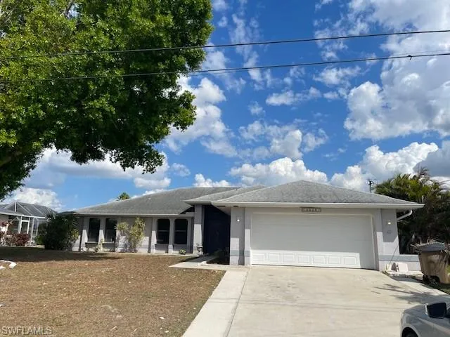 Ranch-style house with an attached garage, stucco siding, and concrete driveway