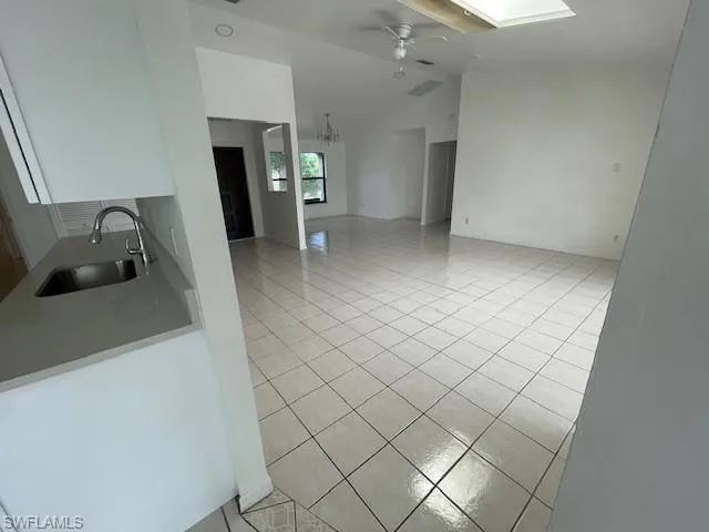 Empty room featuring dark wood-type flooring and a ceiling fan