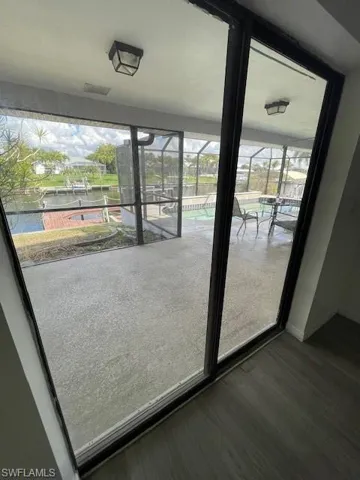 Entryway featuring a sunroom and a water view