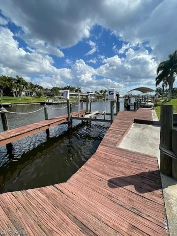 Dock featuring boat lift and a water view