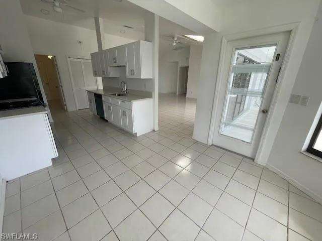 Bathroom with double vanity, a marble finish shower, and dark wood-style flooring