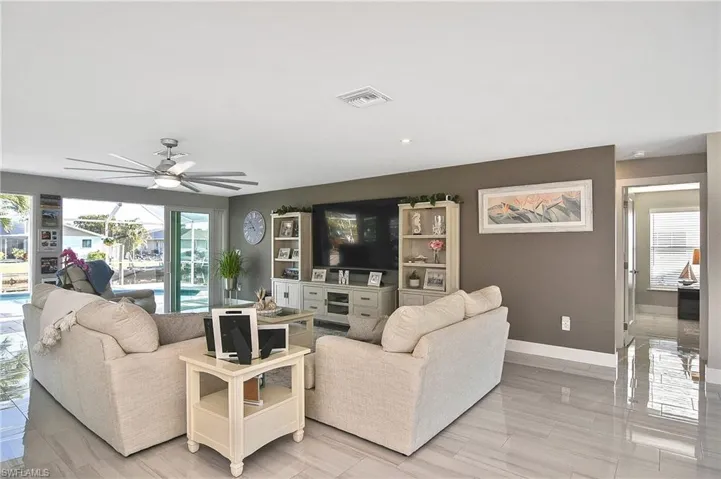 Living area featuring baseboards, ceiling fan, and visible vents