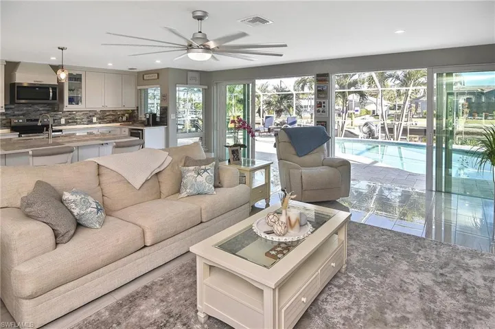 Living area featuring recessed lighting, ceiling fan, and visible vents