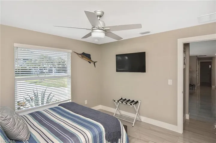 Bedroom with a ceiling fan, baseboards, and visible vents