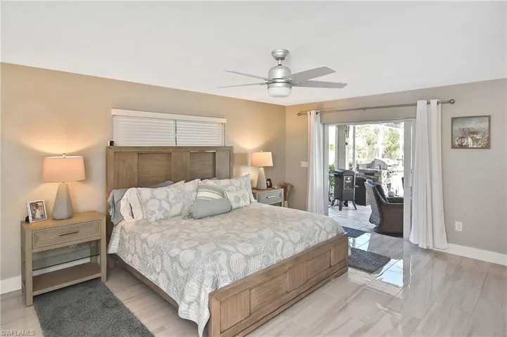 Bedroom with baseboards, access to outside, and ceiling fan