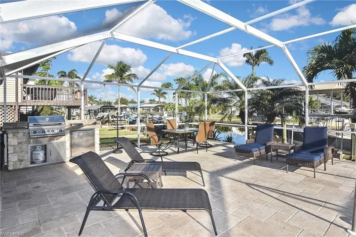 View of patio / terrace with grilling area, area for grilling, and a lanai