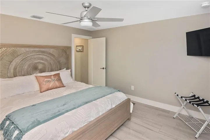 Bedroom with a ceiling fan, baseboards, and visible vents