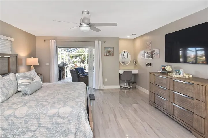 Bedroom with access to exterior, baseboards, visible vents, light wood-style floors, and ceiling fan