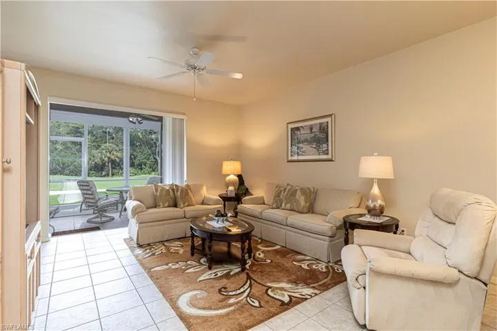 Living room featuring ceiling fan and light tile patterned floors