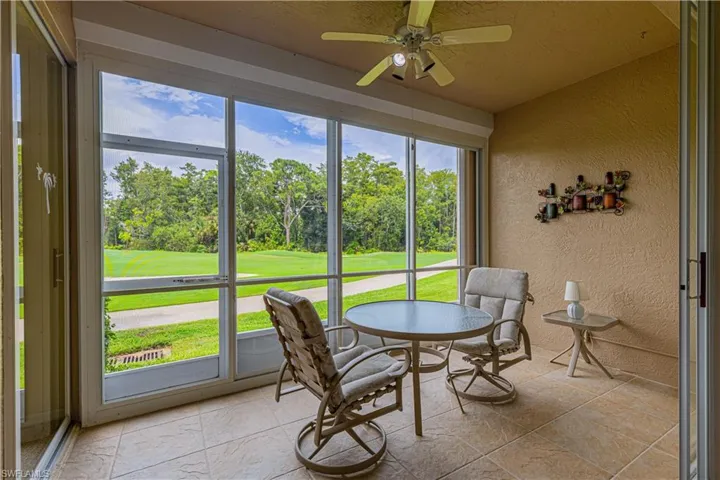 Rear covered Lanai featuring ceiling fan and a healthy amount of sunlight
