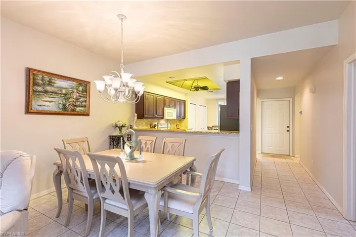 Tiled dining room with a notable chandelier