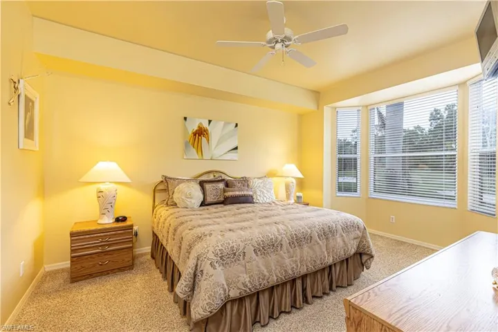 Primary bedroom, carpeted featuring ceiling fan