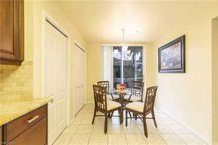 Dining area with a notable chandelier and light tile patterned flooring