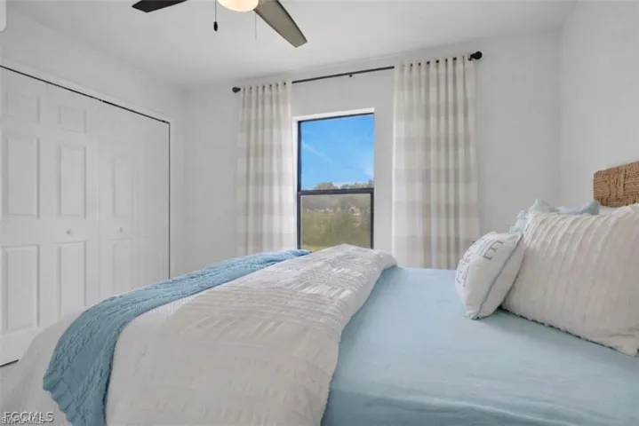 Bedroom featuring a closet and a ceiling fan