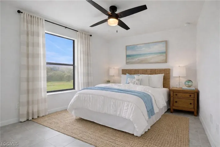 Bedroom featuring baseboards and ceiling fan