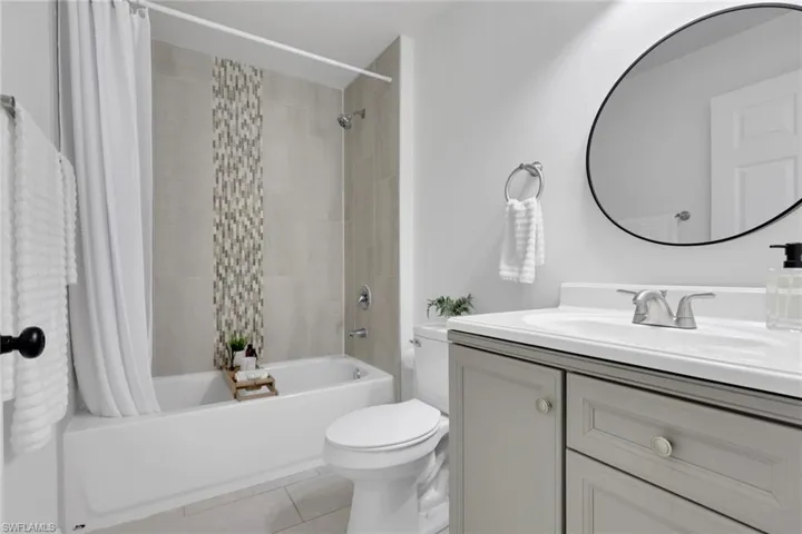 Bathroom featuring vanity, shower / bath combo