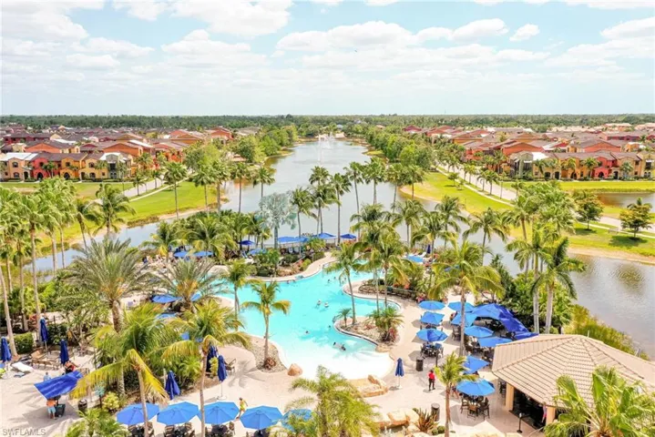 Aerial perspective of resort style pool and Grill Bar, situated nearby body of water