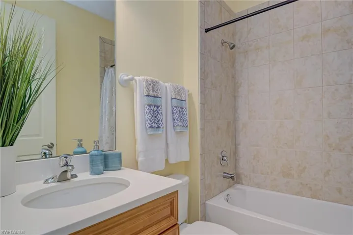 Bathroom with vanity and shower / bath combination