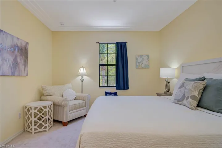 Bedroom with light carpet and baseboards