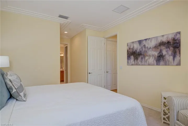 Bedroom with ensuite bathroom, light colored carpet, and recessed lighting