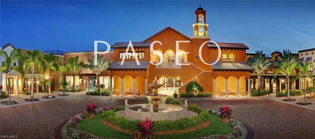 View of building exterior featuring curved driveway