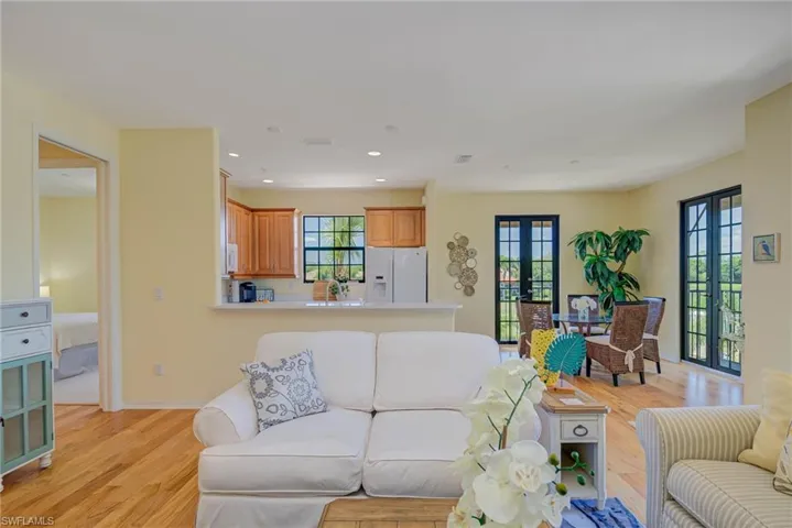 Living room featuring french doors, light wood-style floors, and recessed lighting