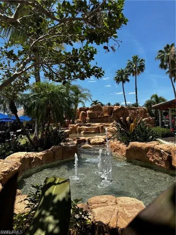 View of community with a small pond