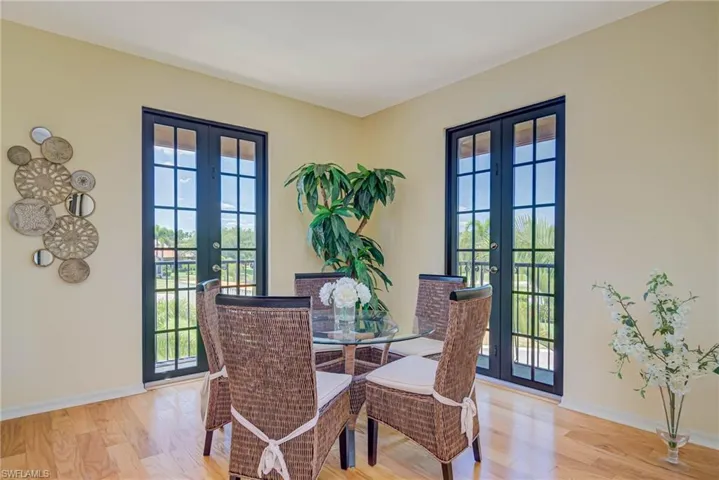 Dining room featuring french doors, healthy amount of natural light, and light wood-style flooring