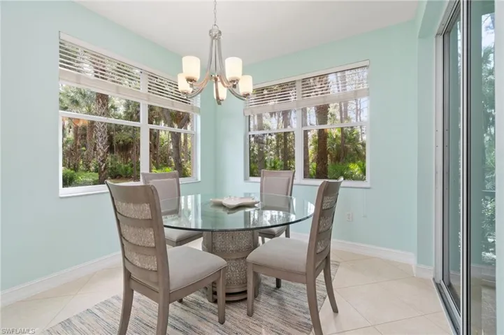 Dining space with an inviting chandelier and light tile patterned floors