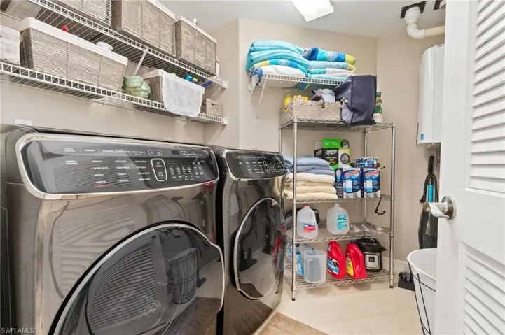 Laundry area with storage and on demand water heater