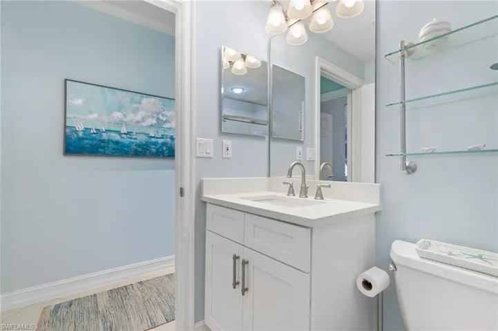 Bathroom featuring vanity, toilet, and tile patterned flooring