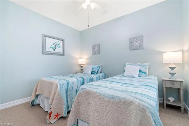 Carpeted bedroom featuring ceiling fan