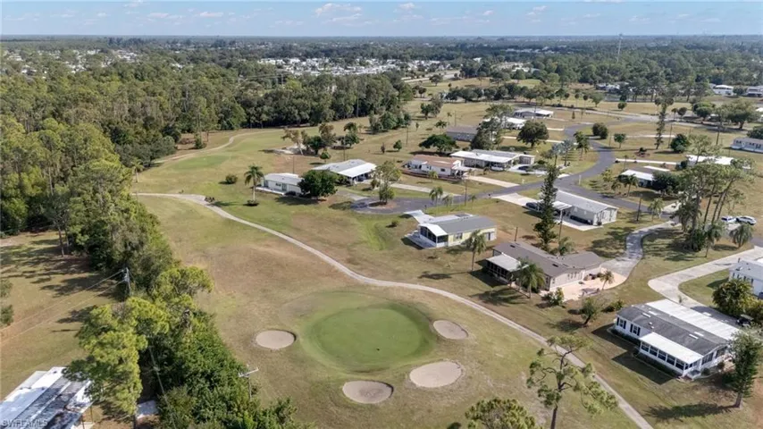 Aerial overview of property's location with a golf club