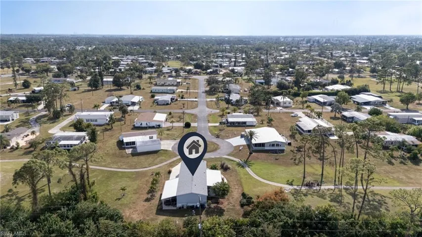 Aerial view of property and surrounding area with nearby suburban area