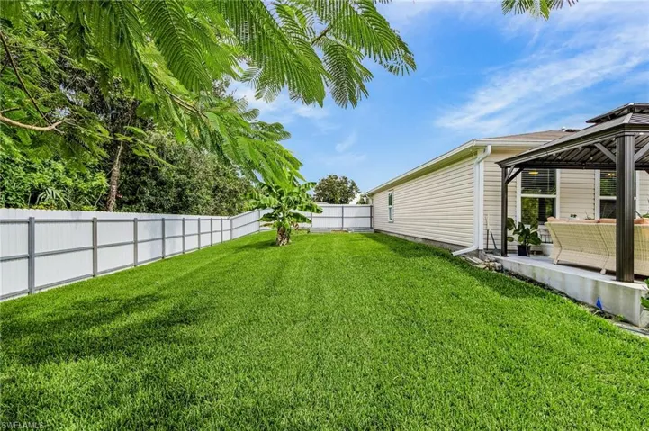 Fenced backyard featuring a patio area, a gazebo, and an outdoor living space