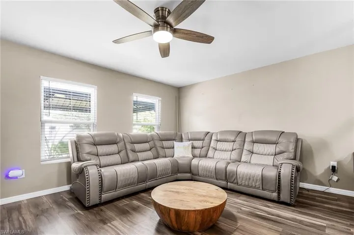 Living area featuring wood finished floors and a ceiling fan